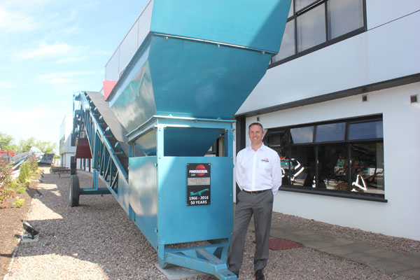 Colin Clements, Global Product Line Director beside a 1966 MK1 screening machine. This was the sixth machine built and remains a permanent feature at the front of our Dungannon Plant